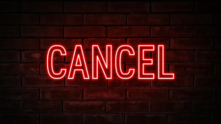 Cancel - red neon light word on brick wall backgroundの写真素材