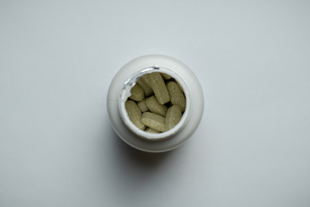 Bottle with pills top view on white backgroundの写真素材