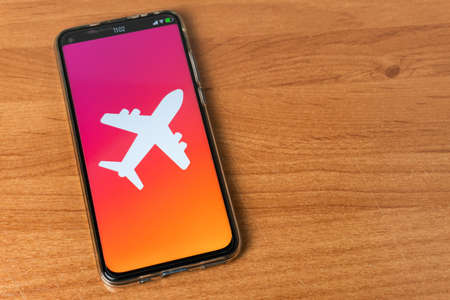Phone with airplane  on tableの写真素材
