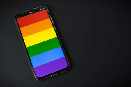 Phone with LGBT flag on black backgroundの写真素材
