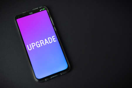 Upgrade - Phone on black backgroundの写真素材