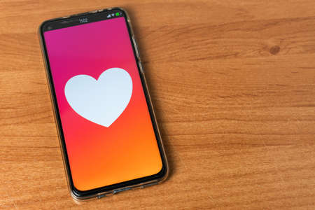 Phone with heart  on tableの写真素材