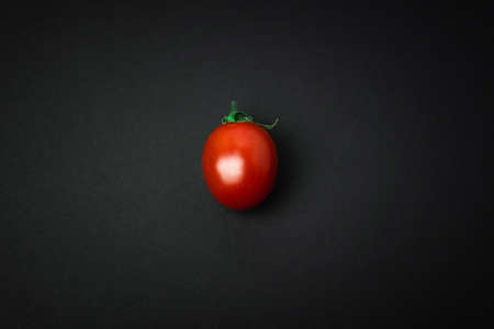 Tomato on black backgroundの写真素材
