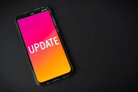 Update - Phone on black backgroundの写真素材