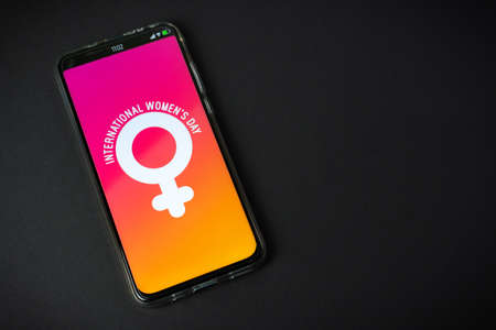 Phone with International Women's Day   on black backgroundの写真素材