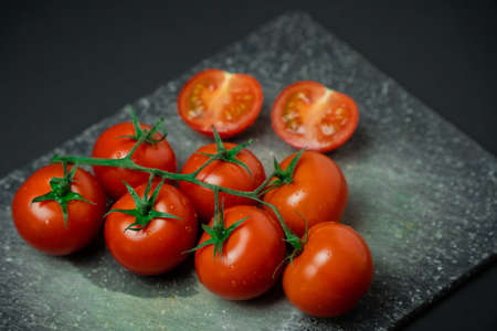 Cherry tomatoes on a cutting boardの写真素材