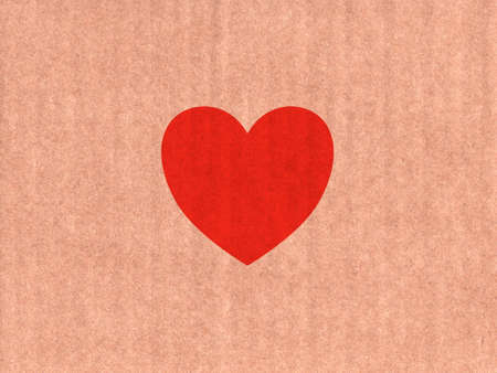 Red heart icon on cardboard textureの写真素材