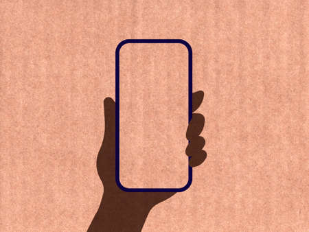 Hand holding a phone on a cardboard textureの写真素材