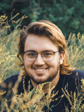 Portrait of a young man in the grassの写真素材