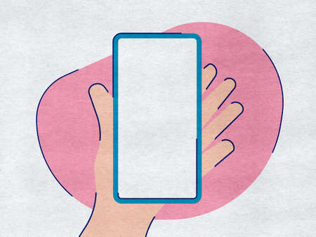Hand holding a phone on a pink paper backgroundの写真素材