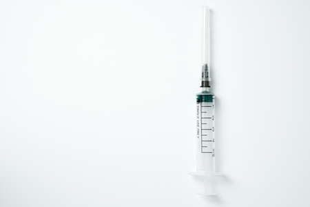 Medical syringe and needle on a light backgroundの写真素材