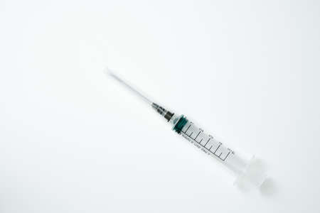 Medical syringe and needle on a light backgroundの写真素材