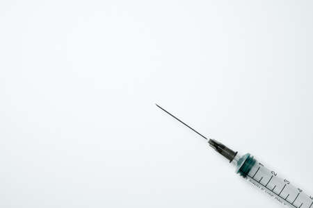 Medical syringe and needle on a light backgroundの写真素材