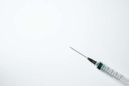Medical syringe and needle on a light backgroundの写真素材