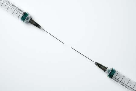 Medical syringe and needle on a light backgroundの写真素材