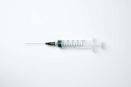 Medical syringe and needle on a light backgroundの写真素材