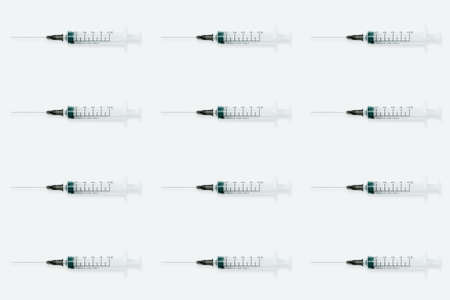 Seamless pattern with medical syringe and needle on light backgroundの写真素材