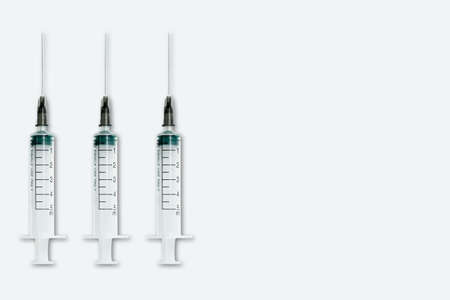 Medical syringe and needle on light background with space for textの写真素材
