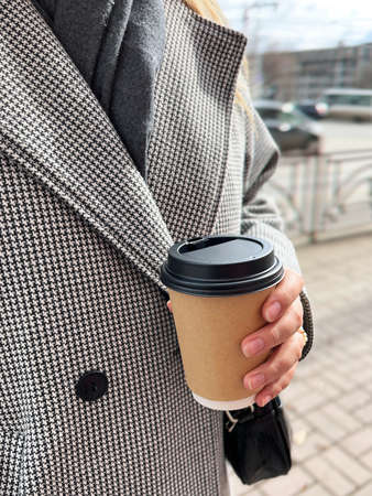 Woman holding a cup of coffeeの写真素材