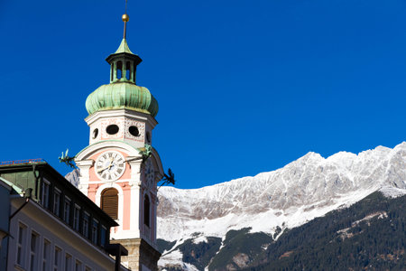 Old tower and alps in Innsbruck, the capital city of the federal state of Tyrol in western Austriaの写真素材