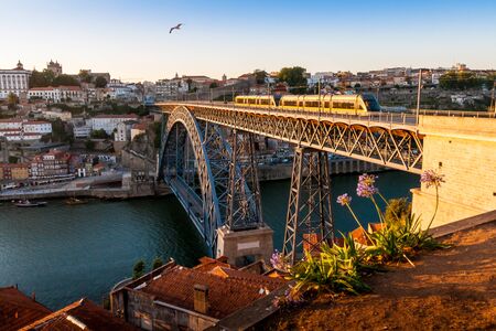 Dom Luis I Bridge in Porto at sunset with metro trainの写真素材
