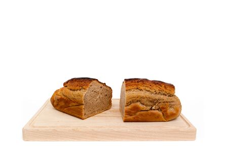 A homemade plumcake standing on a wooden board with a white backgroundの写真素材