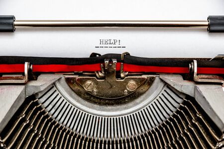 Macro shot of a call for help typed on a vintage typewriter.の写真素材