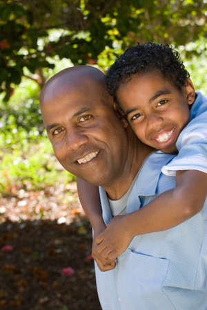 Portrait of an African American father and son outside at the park.の写真素材