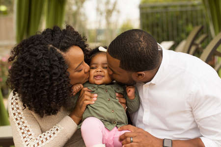 Happy African American family with their baby.