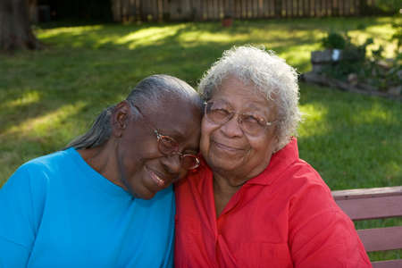 Happy mature African American sisters laughing and smiling.の写真素材
