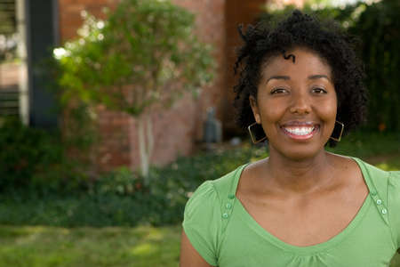 Happy young African American woman smiling outside.の写真素材