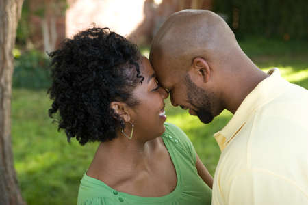 Young African American couple laughing and hugging.の写真素材