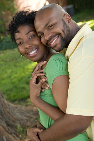 Young African American couple laughing and hugging.の写真素材
