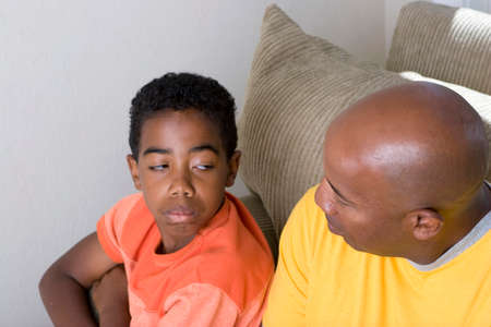 African American father having difficulty parenting his son.の写真素材