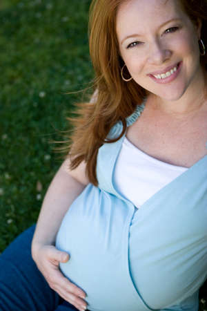 Portrait of a smiling red head pregant womenの写真素材