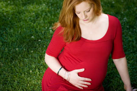 Portrait of a smiling red head pregant womenの写真素材