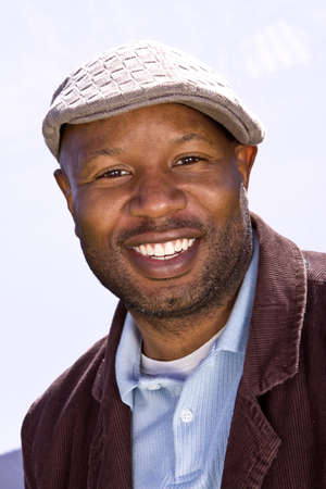 Happy African American man smiling wearing a hat.の写真素材