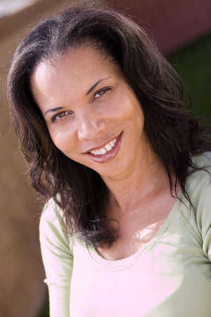 Portrait of a happy African American woman smiling outside.の写真素材