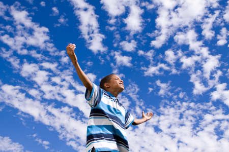Happy African American boy with open arms.の写真素材