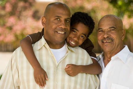 Grandfather with his adult son and grandchild.の写真素材