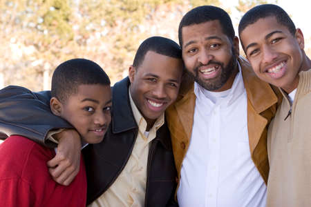 Happy African American father and his teenage sons.の写真素材