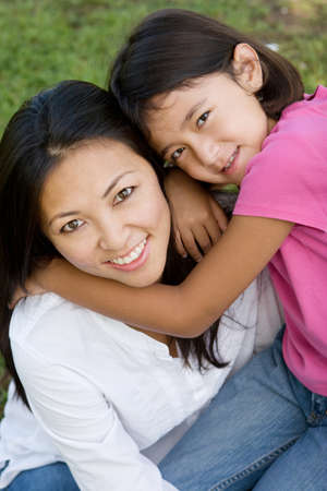 Loving Asain mother and her daughter smiling.の写真素材