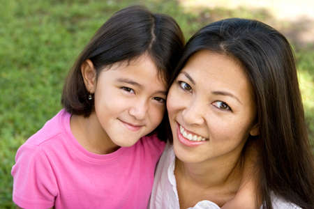 Loving Asain mother and her daughter smiling.の写真素材