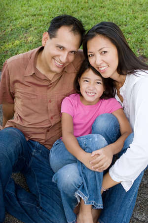 Loving Asain parents and their daughters smiling.の写真素材