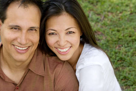 Portrait of an Asian couple laughing and hugging.の写真素材