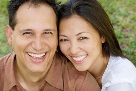 Portrait of an Asian couple laughing and hugging.の写真素材
