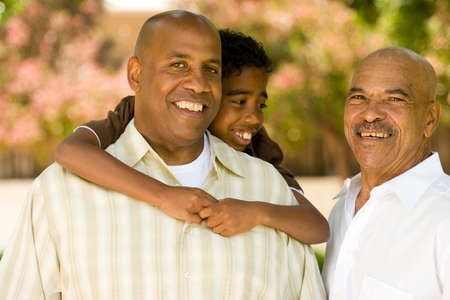 Grandfather with his adult son and grandchild.の写真素材