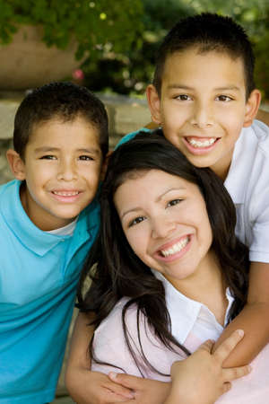 Happy Hispanic mother and her sons.の写真素材