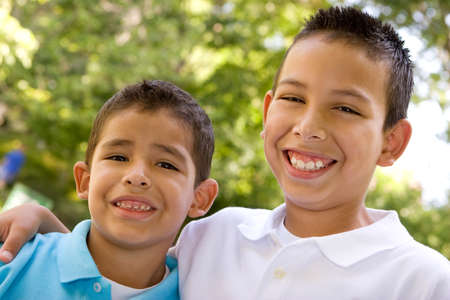 Portrait of happy Hispanic brothers outside.の写真素材