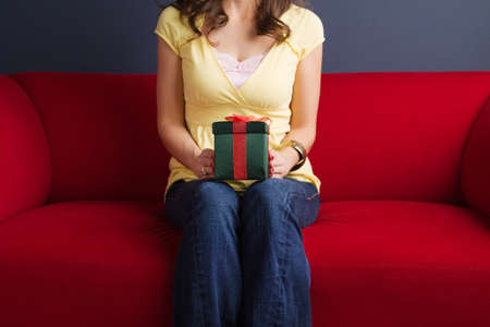 Happy excited woman holding a gift.の写真素材